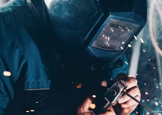 Welder working with steel